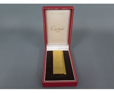 A Cartier gold plated lighter in original box
Condition report: Needs cleaning