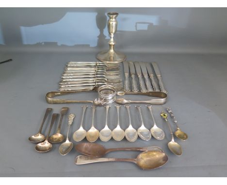 Six silver handled knives, eleven silver handled forks, a small silver hallmarked candlestick, various silver hallmarked item