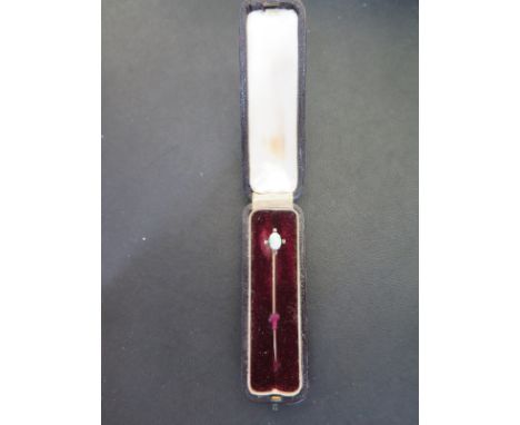 A yellow gold opal pin presumed to be 9ct - Length 55mm - approx weight 1.5 grams - in good condition with original box