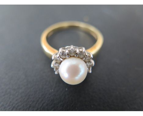 An 18ct yellow gold pearl and diamond ring - size Q - Weight approx. 6gms - in good condition, good lustre to pearl 