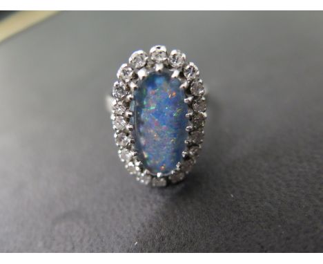 An opal triplet and diamond white gold cluster ring, stamped K18 - Ring size N - Weight approx. 6.6gms 
Condition report: Goo