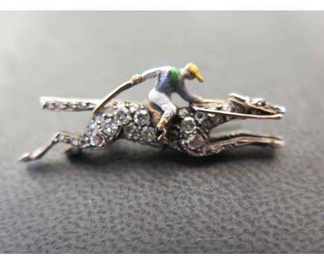 A gold and enamel diamond set brooch in the form of a Racehorse and Jockey - Length 37mm - Total approx. weight 5 gms 
Condit