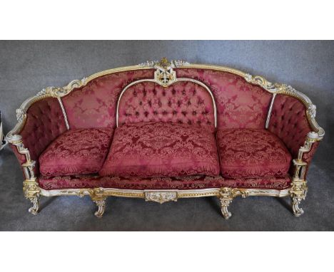 A large gilt and painted framed Rococo style three seater sofa, upholstered in burgundy damask fabric. H 105 x 217 x 90cm 