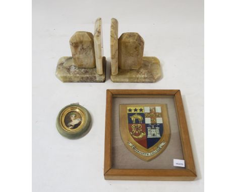 A framed Harrogate College coat of arms wall plaque, signed verso by the College Staff 1944, together with a pair of marble b