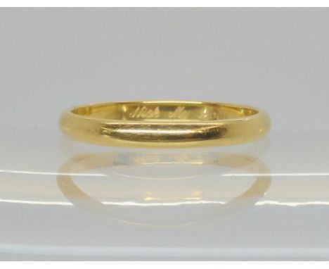 An 18ct gold Cartier wedding ring, the inner shank inscribed Cartier 750 58 (copyright) UX2912, with further Swiss hallmarks 