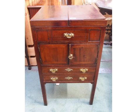 A 19th century mahogany commode with twin hinged lid over pair of cabinet doors over single drawer on square supports Conditi