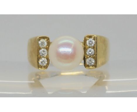 A 9ct gold pearl and diamond dress ring, the pearl measures approx 8.2mm, set with estimated approx 0.18cts of brilliant cut 