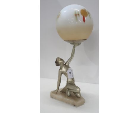 An Art Deco lamp modelled as figure of a woman holding a globe shade Condition Report:restored to arm and missing a finger