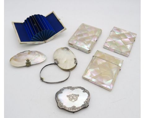 A collection of mother of pearl items, comprising two card cases, two white metal-mounted concertina purses, a shell purse, a