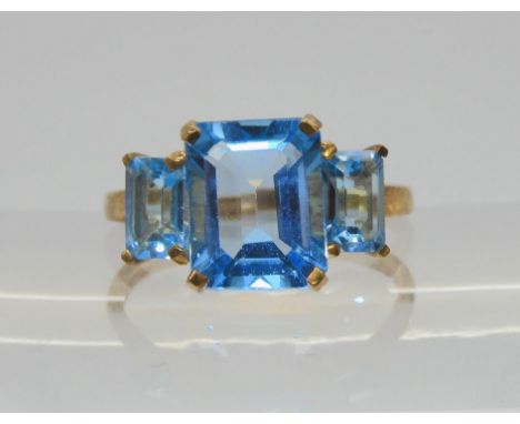 &nbsp;A 9ct gold three stone blue topaz ring, size P1/2, weight 2.6gms Condition Report:Available upon request