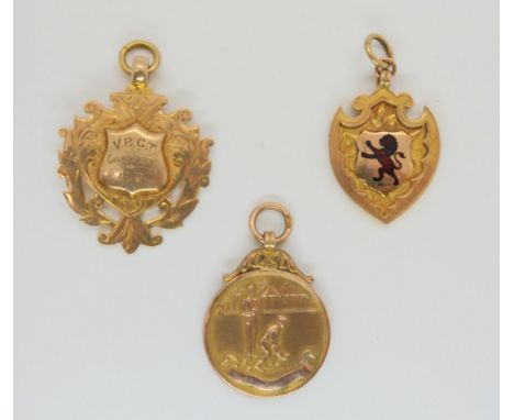 A 9ct gold red enamel lion medallion, together with two further bowling medals, weight together 24gms Condition Report:Availa
