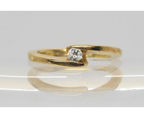 A 9ct gold diamond cross over solitaire ring, set with a 0.10ct brilliant cut diamond, size L1/2, weight 2.7gms Condition Rep