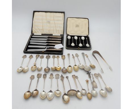 A collection of silver flatware including silver souvenir spoons, most with UK hallmarks, some white metal examples, a cased 