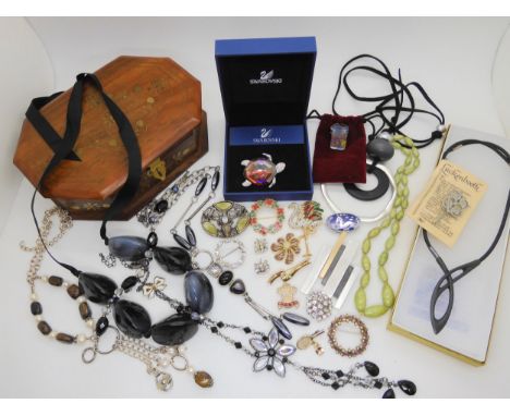 A Swarovski turtle brooch, a Miracle 'Stag' brooch, Murano glass ring, and other items Condition Report:Not available for thi
