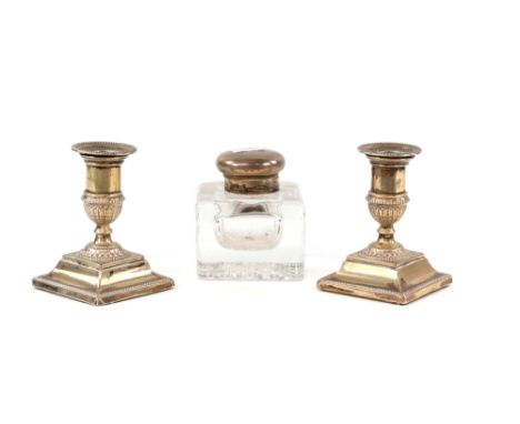 Edwardian silver top glass inkwell, hallmarked London 1905 and a pair of modern silver squat form candlesticks on step bases,