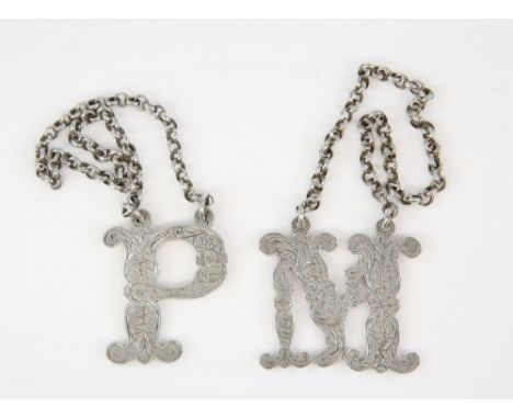 Two Victorian silver decanter labels 'M' and 'P' with engraved decoration, by Charles Rawlings &amp; William Summers, London,