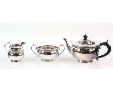 George V silver three-piece tea service, by C T Burrows &amp; Sons, Birmingham 1914, each of squat form with scrolling border