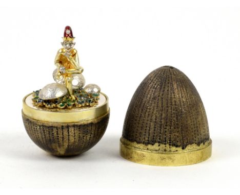 Stuart Devlin, a silver-gilt surprise egg, by Stuart Devlin, London, 1985, limited edition number 15, the textured egg openin