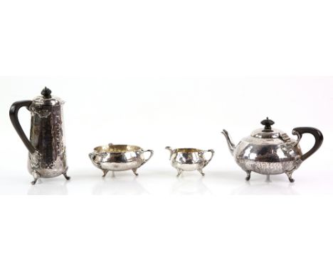 Edward VII Arts and Crafts silver four-piece tea-service, by James Ramsay, London 1903, each with hammered finish and flame-c