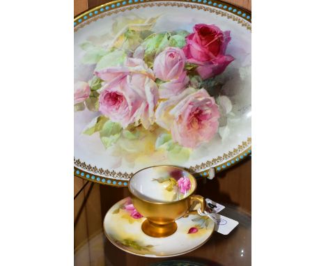 A ROYAL WORCESTER TEACUP AND SAUCER, AND A ROYAL DOULTON BOWL, PAINTED WITH ROSES, the small teacup having a gilt exterior, t