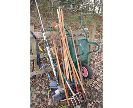 A COLLECTION OF GARDEN TOOLS to include spade, fork, brush, wheelbarrow etc