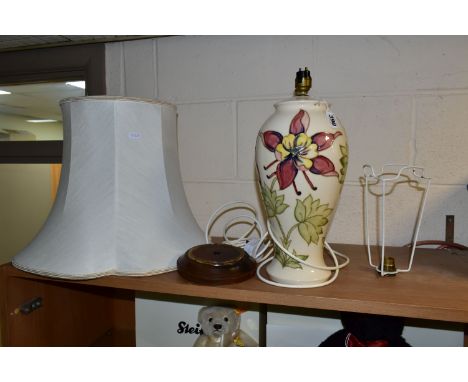 A MOORCROFT POTTERY TABLE LAMP, in the Columbine pattern on a cream ground, with loose wooden base and large cream shade, imp