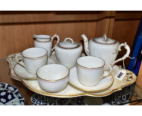 A WHITE PORCELAIN BACHELOR TEA SET AND TRAY, with a red and gold gilt lined border, foliate detail on handles, comprising tra