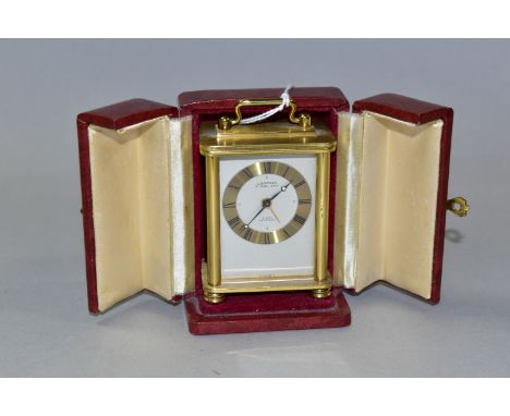 A LOOPING MINIATURE 8 DAY CARRIAGE STYLE CLOCK, in burgundy leather covered case, height of clock (including handle) 8.5cm (1