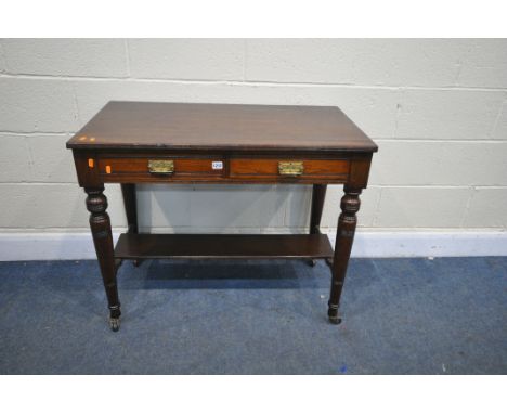 AN EDWARDIAN MAHOGANY SIDE TABLE, with two frieze drawers, on turned legs, united by an undershelf, on ceramic casters, lengt