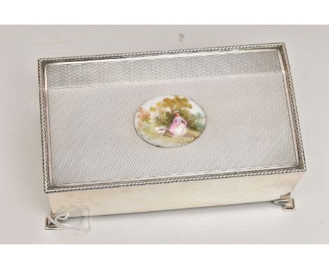 AN EARLY 20TH CENTURY SILVER BOX, of a rectangular form, engine turned pattern, hinged cover fitted with a painted ceramic ce