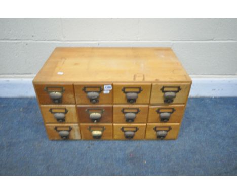 A LIGHT OAK TWELVE DRAWER INDEX CABINET, width 68cm x depth 40cm x height 37cm (condition - one drawer front broken, surface 