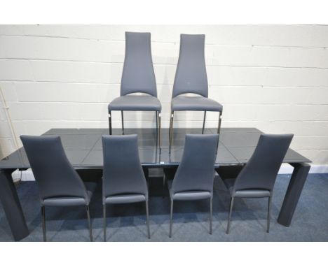 A CALLIGARIS ESTESO GRAPHITE GLASS EXTENDING TABLE, with a pull out leaves, on a smart mechanism, two on shaped legs, extende