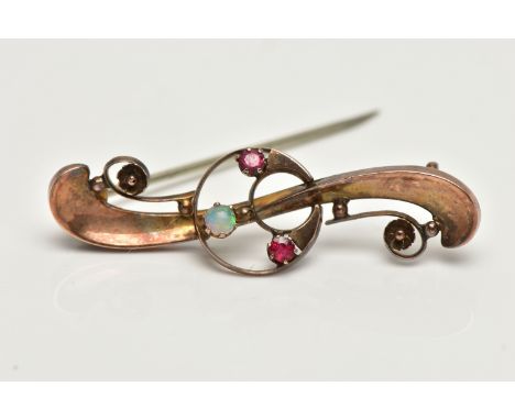 A 9CT GOLD OPAL AND RUBY BROOCH, openwork crescent to the centre set with an opal cabochon and two garnets, to the scrolling 