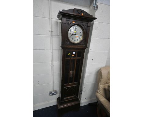 AN EARLY 20TH CENTURY OAK CHIMING LONGCASE CLOCK, with a brass and silvered dial, on a glazed trunk, with and pendulum, heigh