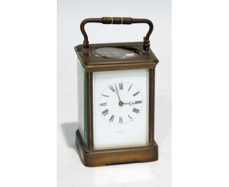 A CIRCA 1900 FRENCH BRASS CASED CARRIAGE CLOCK, the back plate stamped E.M & Co, The white enamel dial inscribed  Hall &  Co,