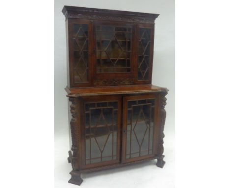 NINETEENTH CENTURY CARVED MAHOGANY DISPLAY CABINET, the dentil moulded cornice above a scroll carved frieze and three astraga