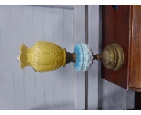 VICTORIAN BLUE AND YELLOW GLASS OIL LAMP, of pedestal form with embossed  brass base, moulded fading blue glass reservoir and