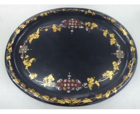 VICTORIAN BLACK LACQUERED AND MOTHER O'PEARL INLAID TRAY, of oval form, decorated with scrollwork panels tied by gilt fruitin