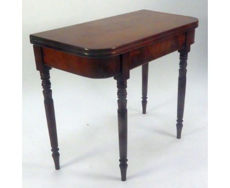 LATE GEORGIAN MAHOGANY CARD TABLE, the rounded oblong fold over top, above a flame cut frieze and raised on turned legs, 29 1