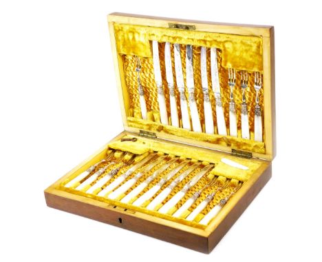 A set of Edwardian silver plated mother of pearl and bright cut entree knives and forks, in a mahogany canteen, settings for 