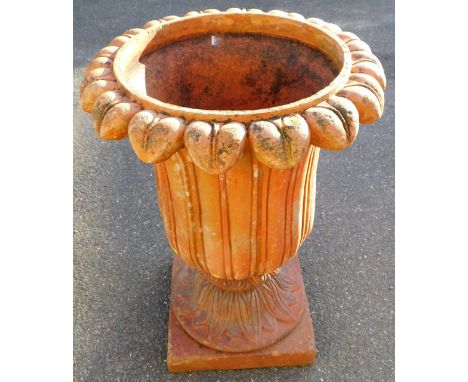 A fire clay classical style urn planter, with floral top on an inverted acanthus stem and plain square base, 68cm high, 49cm 