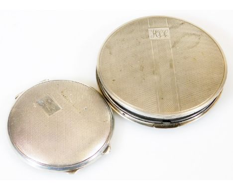 A George VI silver powder compact, of circular form, partially engine turned and initialled with a plain interior plate and m