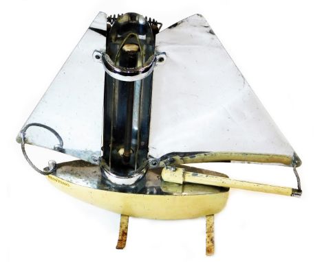 A mid 20thC Art Deco chrome plated Bunting ship heater, with two sails, central bulb and shaped stand, partially decorated in