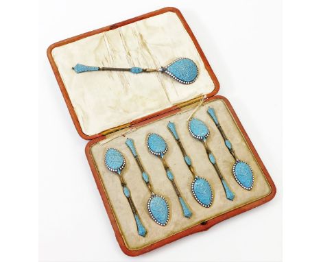 An early 20thC Russian style enamel base metal and inlaid spoon set, with serving spoon and shaped teaspoons, in turquoise de