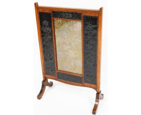 A late Victorian oak framed Art Nouveau fire screen, with central rectangular floral section and oxidised metal studded mount