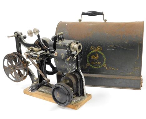 An early 20thC Pathe KOK 28mm projector, with articulated handle, with metal frame on pine base with tin cased top, 43cm high