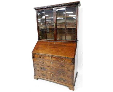 An George III mahogany bureau bookcase, the upper section with a pair of astragal glazed doors, raised above a fall, with ova