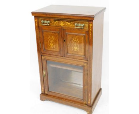 An Edwardian rosweood Sheraton revival cabinet, of rectangular form with a plain moulded top raised above a frieze drawer, in