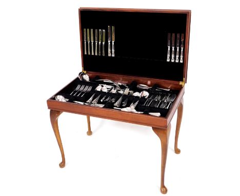 A 20thC mahogany finish freestanding canteen, of rectangular form with a leather tooled top, complete with various flatware, 