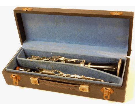 A 20thC Martin Freres French three piece clarinet, with additional mouthpiece, partially ebonised with chrome mounts, in fitt